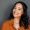 Close up face of young woman with beautiful smile isolated on grey wall with copy space. Carefree and successful multiethnic girl standing on grey background. Latin hispanic woman looking at camera against grey wall with a big whitening teeth smile.
