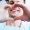 Cheer of heart. A patient with white and healthy smile in the center of a heart made from two hands of a doctor and a patient which is telling about pleasant emotions of the appointment.